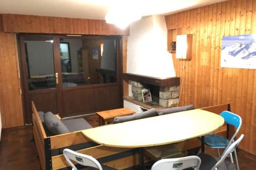 un salon avec une table et une cheminée dans l'établissement Chinaillon Gd Bo vue panoramique - appart 5 pers, au Grand-Bornand
