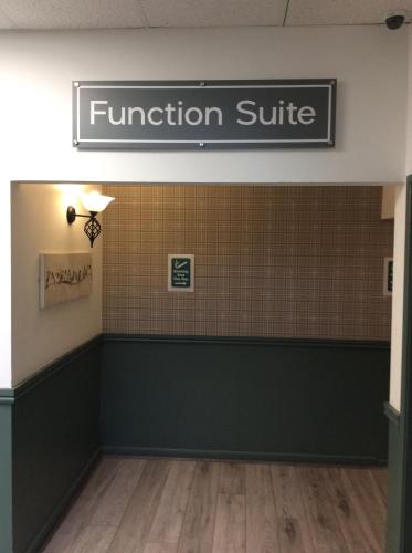 a waiting room with a function suite sign on the wall at Greenland's Inn in Longbridge