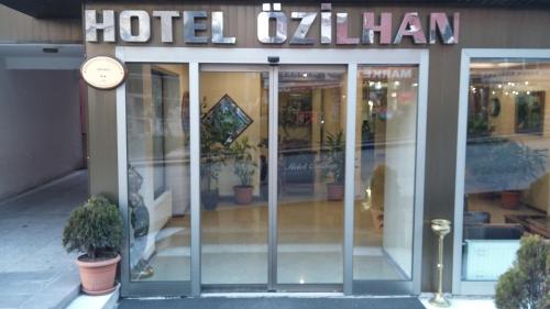 a hotel with a clock on the front of a building at Ozilhan Hotel in Ankara