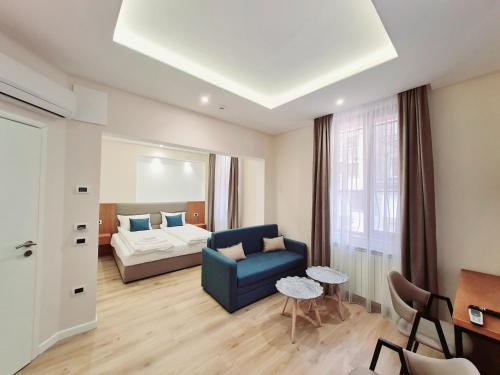 a living room with a bed and a blue couch at Hotel House K21 in Sofia
