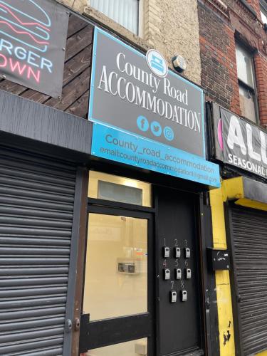 a store front with a sign above the door at County serviced accommodation in Liverpool
