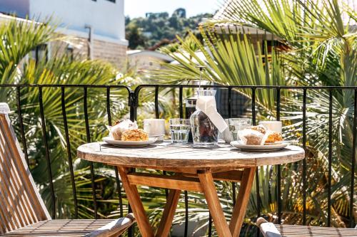 a table with plates of food on a balcony at Onetangi Beach Apartments in Onetangi