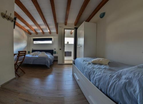 a bedroom with two beds and a dining room at B&B Residenza Marina in Marina di Carrara