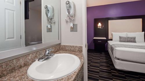 
a bathroom with two sinks and a mirror at SureStay Hotel by Best Western Beverly Hills West LA in Los Angeles
