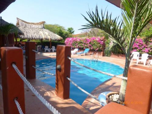 una piscina con recinzione di corda intorno ad essa di Vista de las Rocas a Ixtapa