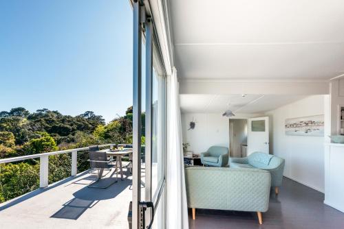 a view from the balcony of a house at Roses Bach - Stay Waiheke in Onetangi