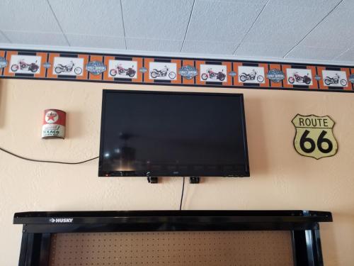 a flat screen tv hanging on a wall at Galaxy of Harley Bikers Between Bryce and Zion in Hatch