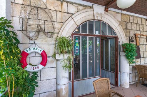 a building with a door with a sign on it at Apartments Klaric in Krilo