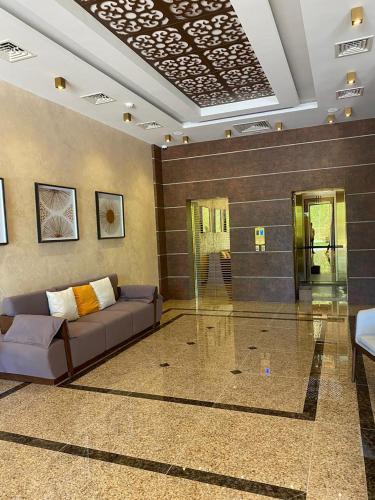 a living room with a couch and a glass floor at Dreamland deluxe apartment in Chakvi