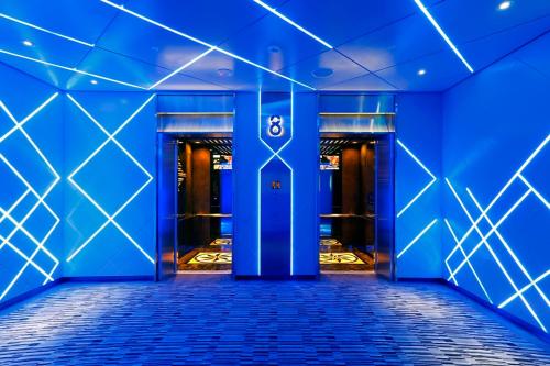 a blue hallway with a door with the number eight at Golden Tulip - Aesthetics in Zhunan