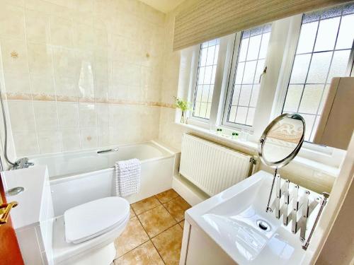 a bathroom with a sink and a toilet and a tub at The Shoulder of Mutton in Bradwell