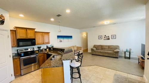 a large kitchen and living room with a couch at Casa Flamingo in Cape Canaveral