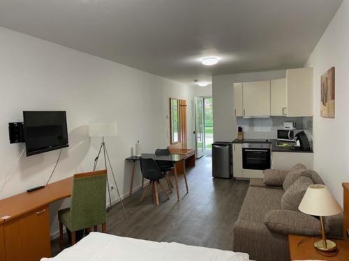 a living room and kitchen with a couch and a table at Stilvoll Wohnen in Oldenburg Kreyenbrück Apartments in Oldenburg