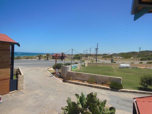 a parking lot with a view of the ocean at Seaspray Beach Holiday Park in Dongara