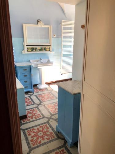 a bathroom with a sink and a mirror at Manoir de Champvert in Les Vans