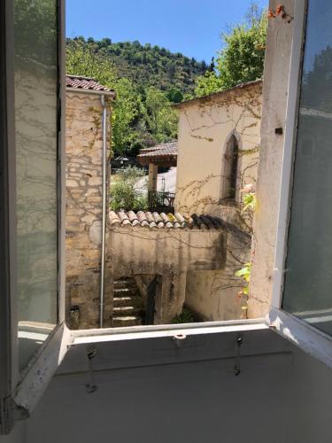 an open window with a view of a building at Manoir de Champvert in Les Vans