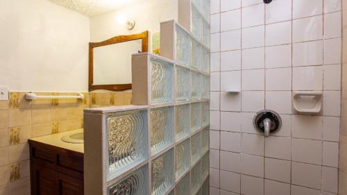 a bathroom with a sink and a mirror at Moonlight Cottage in East End Village