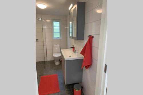 a bathroom with a white sink and a toilet at Veras Veranda i Köpingsvik in Köpingsvik