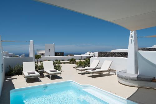 a swimming pool on a patio with chairs and a swimming pool at La Ponta Villas & Suites in Akrotiri
