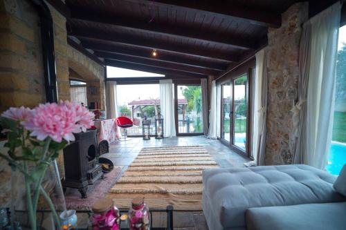 a living room with a couch and a fireplace at Stone Villa Lagonisi in Lagonissi
