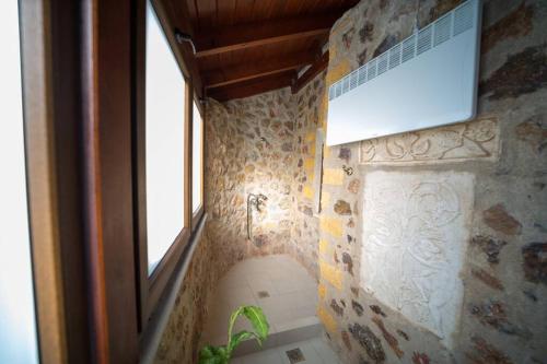 a bathroom with a sink and a window at Stone Villa Lagonisi in Lagonissi