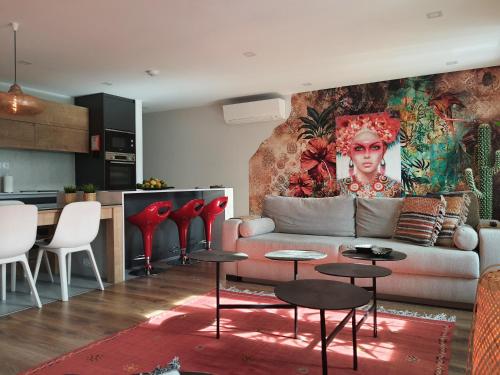 a living room with a couch and tables and a kitchen at Exotic Fusion double Suite in Lisbon