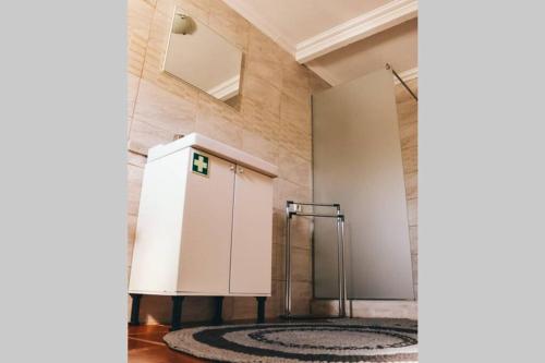 a shower stall in a room with a rug at Quinta do Pica-Pau Amarelo in Grândola