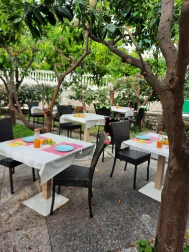 a patio with tables and chairs and umbrellas at Rione San Carlo in Finale Ligure