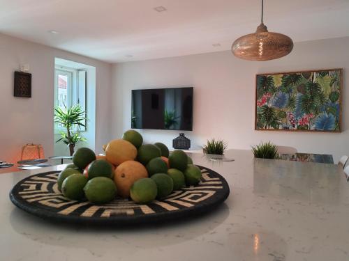 a plate of fruit on a table in a room at Exotic Fusion double Suite in Lisbon