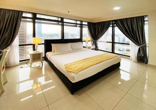a hotel room with a large bed and a large window at Eastern Suites @ Times Square KL in Kuala Lumpur