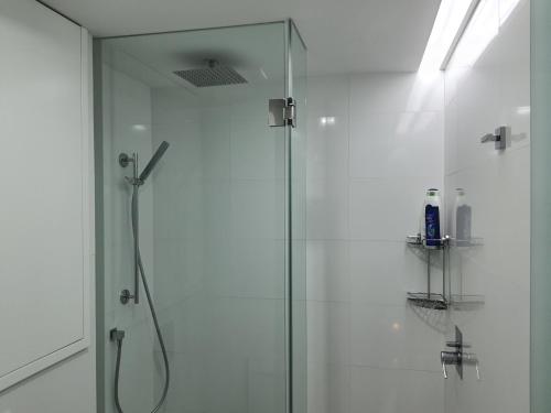 a shower with a glass door in a bathroom at Exotic Fusion double Suite in Lisbon