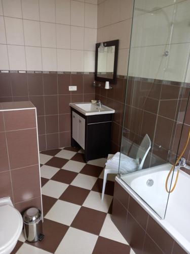 a bathroom with a tub and a sink and a toilet at Le Chateau de Buchy in Buchy