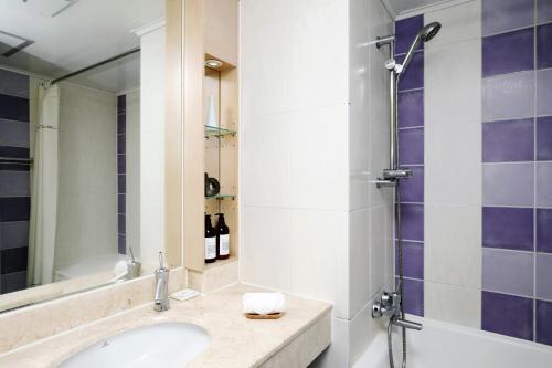 a bathroom with a sink and a shower at Bloom Hotel in Seogwipo
