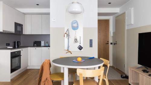 a small kitchen with a table and chairs in a room at Bob W City Centre in Helsinki