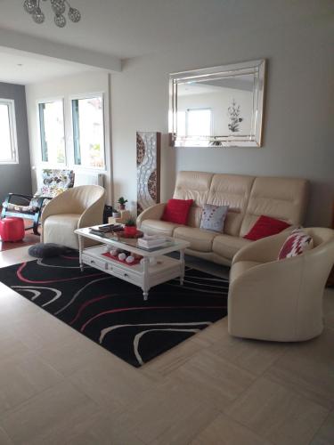 a living room with a couch and a coffee table at 19,Avenue John Kennedy in Breteil