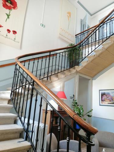 a winding staircase in a home with a stair case at VTF Le Domaine Les Hautannes in Saint-Germain-au-Mont-dʼOr