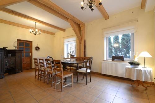 a dining room with a table and chairs and a window at Pensjonat Akacja in Kudowa-Zdrój