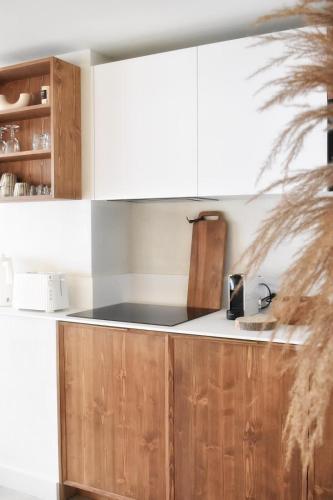 a kitchen with wooden cabinets and a counter top at Apartment WABI-SABI by JAPANDI home in Megève