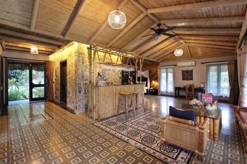 a large living room with a wooden ceiling at Mai Chau Ecolodge in Mai Chau