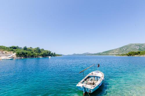a boat sitting in the middle of a large body of water at Apartments Melany in Slano