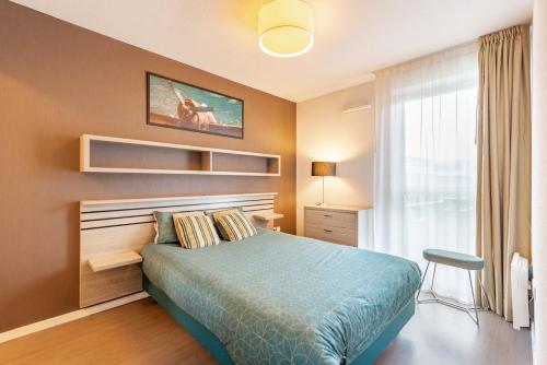 Un pat sau paturi într-o cameră la Auriol