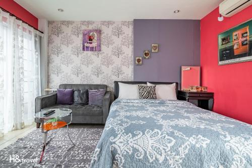 a bedroom with a bed and a couch at White Cotton Candy Homestay in Hualien City