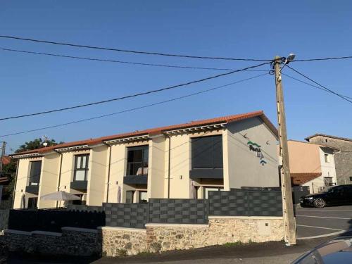 a building with steps in front of a house at Adosado Marea Baja 1 zona de playa y montaña in Llanes