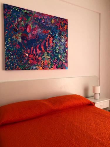 a bedroom with a painting hanging above a bed at Al Saliceto Hotel in Patti