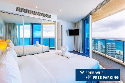 a hotel room with two beds and a large window at H Luxury Residence Apartments - Holiday Paradise in Gold Coast