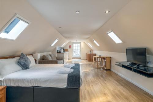 a bedroom with a bed and a living room at Victoria Court Suites - Aberdeen in Aberdeen