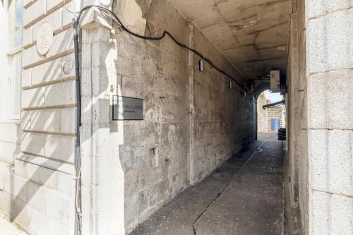 an alley with a sign on the side of a wall at Victoria Court Suites - Aberdeen in Aberdeen