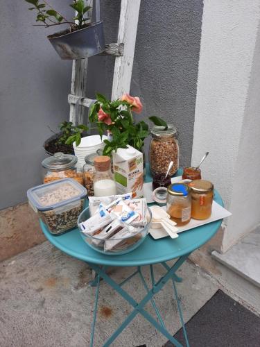 a blue table with jars of food on it at Rione San Carlo in Finale Ligure
