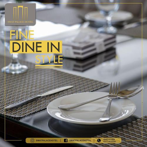 a plate and fork and knife on a table at Swat Palace Hotel By Northin in Mām Derai