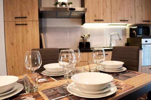 a table with wine glasses and plates on it at Borgo San Lorenzo Roma in Rome